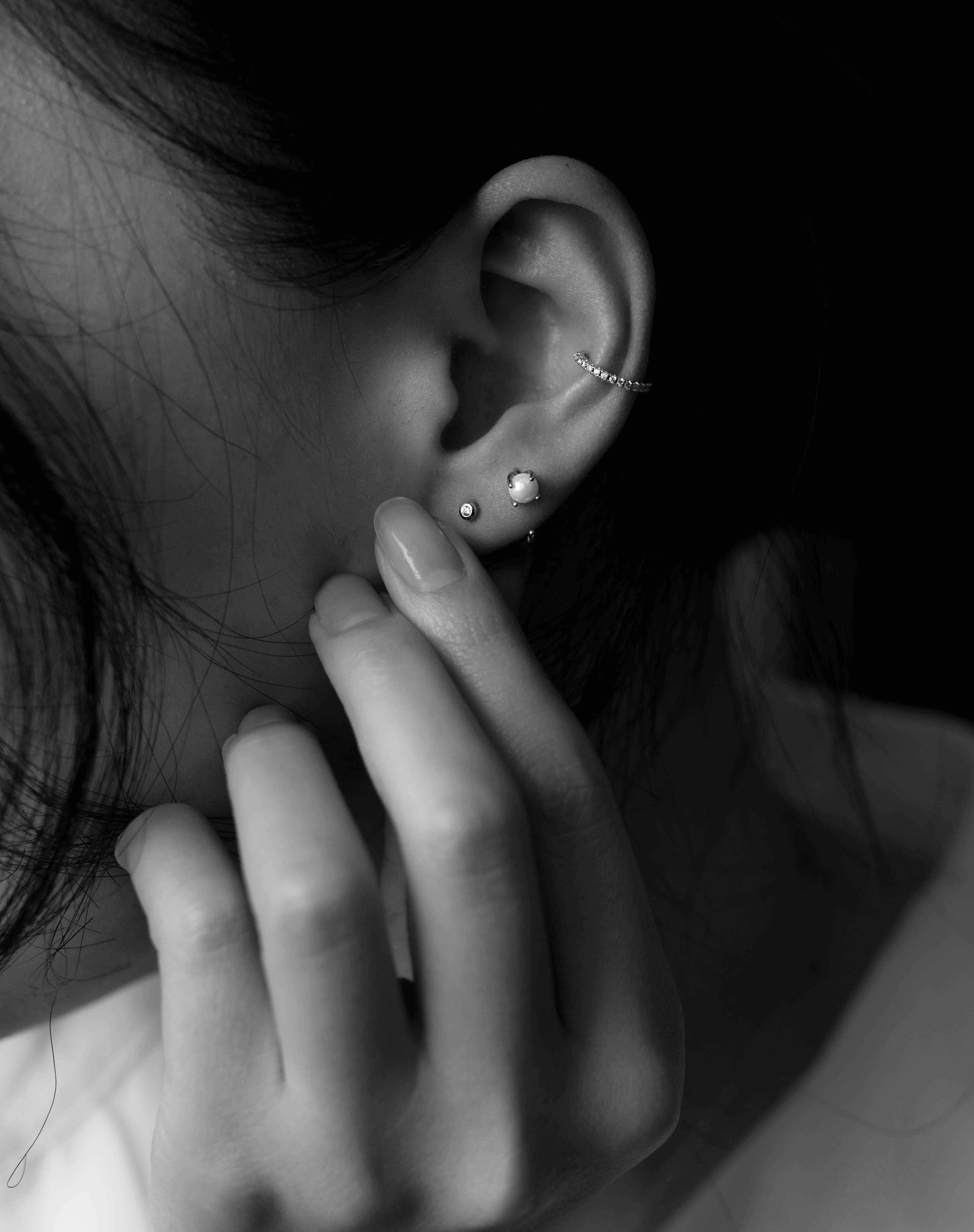 picture of a woman's ear wearing an earing